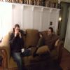 Adam playing harmonica, Ethan intently watching. Guess what I photoshopped off the coffee table! 